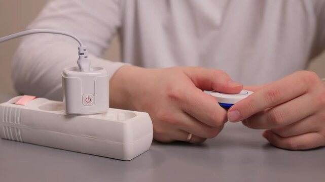 Smart plug handson setup. User demonstrates quick smart socket operation. Individual showcases effortless installation and immediate control of smart electrical devices