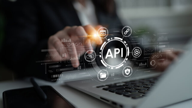 Professional hand interacting with futuristic API interface on laptop screen, showcasing digital technology and data integration in a modern workspace. Entropy.