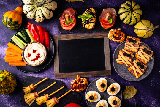 Halloween appetizers with pumpkin hummus deviled eggs and mummy snacks