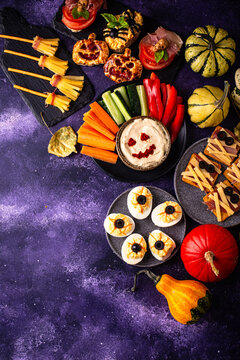 Halloween appetizers with pumpkin hummus deviled eggs and mummy snacks