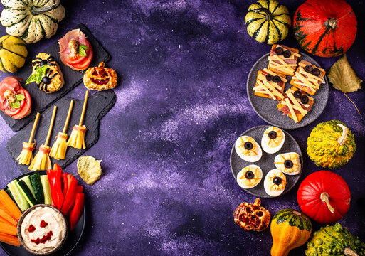 Halloween appetizers with pumpkin hummus deviled eggs and mummy snacks