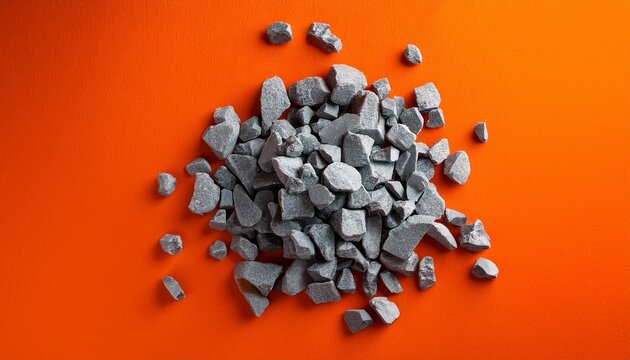 pile of gray rubble on bright orange backdrop top view