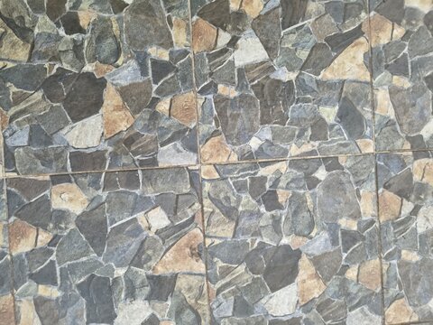 Random pattern of grey and brown stone floor tiles