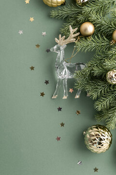 Festive Christmas Holiday Decoration with Crystal Reindeer and Gold Ornaments on Green Backdrop