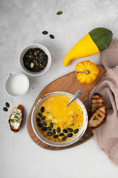 Creamy squash soup bowl, fall vegetarian lunch top view