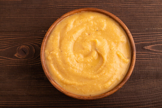 Pea cream soup, Puree, porridge in wooden bowl on wooden, top view, flat lay, close up