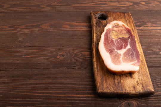Dry-aged steak, Pork ham on brown wooden, side view, copy space
