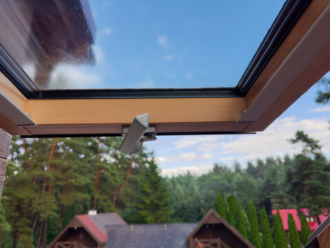 View through the open roof window with handle on foreground