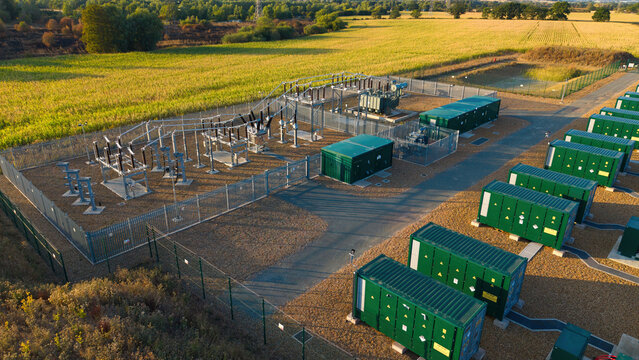 Aerial view of Battery Energy Storage System at BESS Grendon with green battery containers and electrical infrastructure in Northampton, England, United Kingdom.