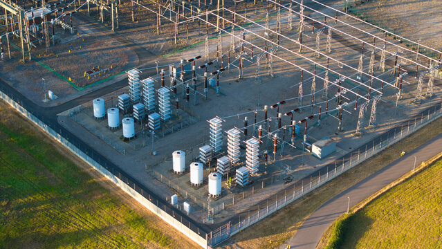 Aerial view of Grendon national grid station featuring electrical transformers, switchgear, and power infrastructure surrounded by a perimeter fence in Northampton, England, United Kingdom.