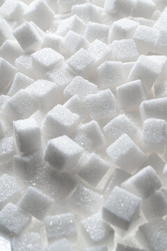 Pile of white sugar cubes background