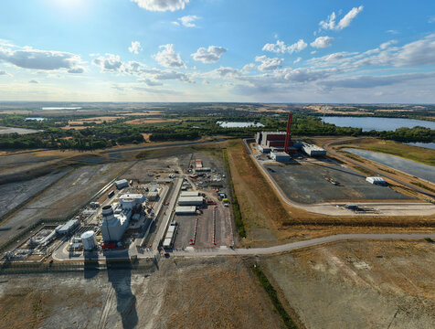Aerial view of the Rookery South ERF and Millbrook power plant facilities situated in a rural landscape with industrial infrastructure and nearby lakes in Stewartby, England, United Kingdom.