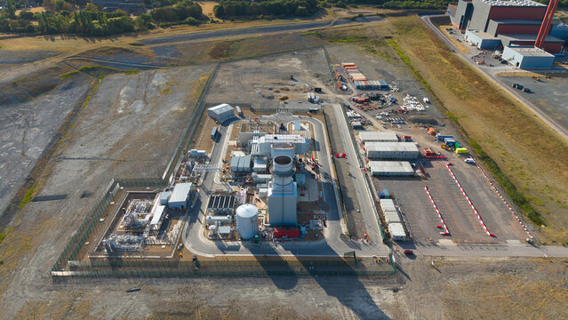 Aerial view of Millbrook Power Plant featuring industrial infrastructure, storage tanks, and surrounding grounds in Stewartby, England, United Kingdom.
