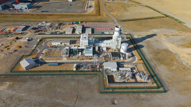 Aerial view of Millbrook Power Plant showing industrial infrastructure, storage tanks, and surrounding fields in Stewartby, England, United Kingdom.
