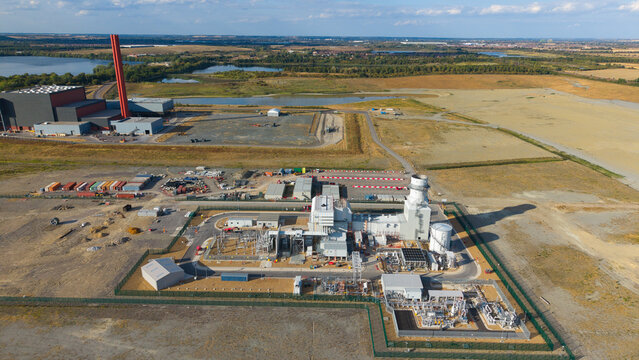 Aerial view of Millbrook Power Plant featuring industrial structures, power generation facilities, and surrounding open landscape in Stewartby, England, United Kingdom.