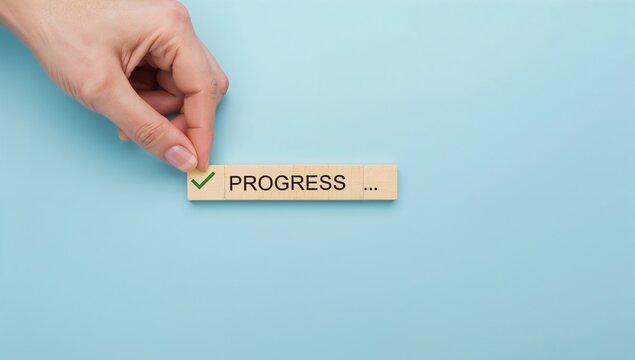 Checklist and task progress tracking concept. A hand placing the final checkmark on wooden blocks in a progress bar, task completion, productivity, goal setting, and efficient project management.