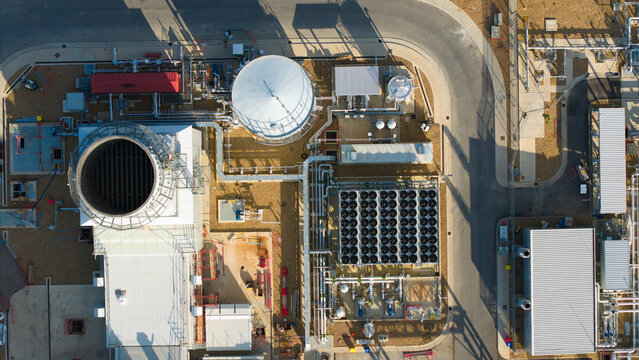 Aerial view of Millbrook Power Plant showing cooling towers, industrial infrastructure, pipes, and storage tanks in Stewartby, England, United Kingdom.
