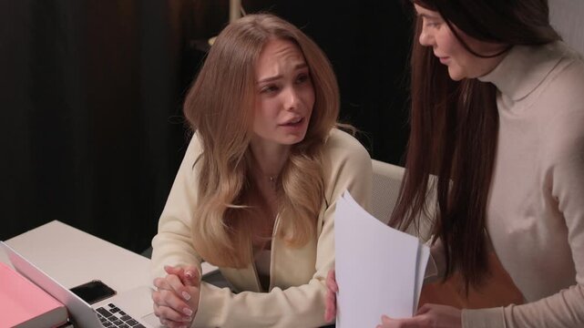 Candidate reviews interview. Job seeker scrutinizes curriculum vitae during interview. Applicant attentively reviews their curriculum vitae during professional interview session