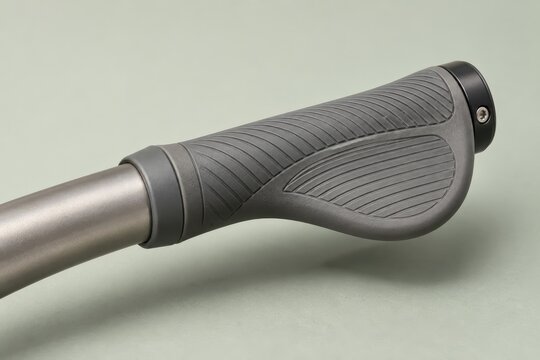 Ergonomic grey bicycle handlebar grip with textured rubber and metal clamp
