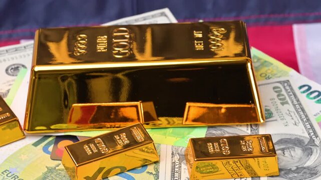 featuring US dollar and euro banknotes and gold bars.