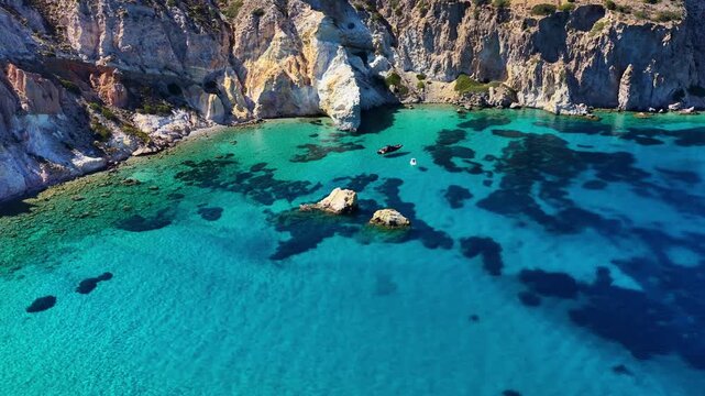 Drone view of Firopotamos beach in Milos, holidays on a Greek island in the Cyclades archipelago, vacation in Greece, aerial view of clear turquoise Mediterranean sea with cliffs