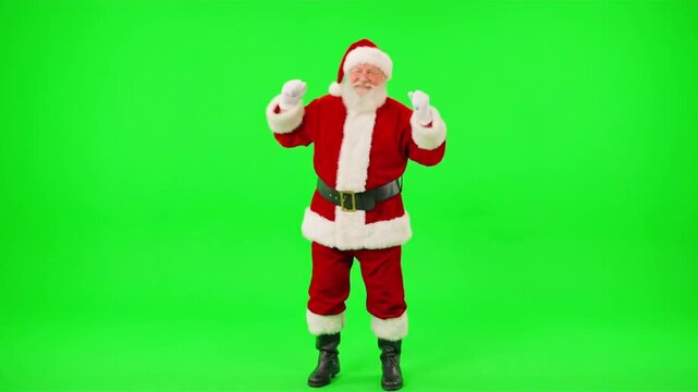 Santa Claus with white beard wearing traditional red suit cheering with arms raised on green screen