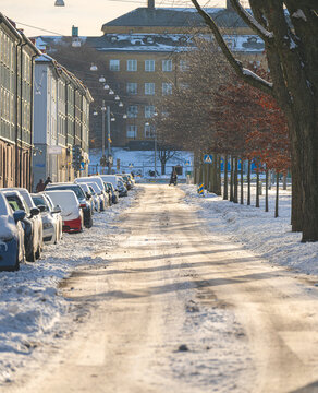 Snowy urban street with pedestrians cars and winter atmosphere.