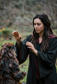 Fantasy roleplay and magic, young woman in wizard robe interacting with mythical creature in forest, creative storytelling and imagination
