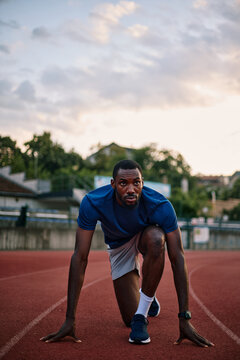 Determined athlete preparing for a sprint race on track