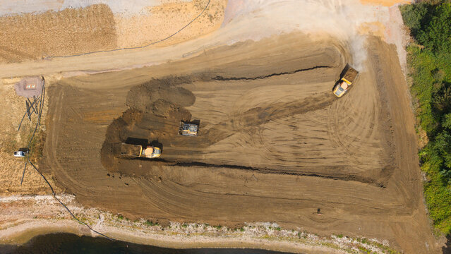 Aerial view of heavy machinery and excavators performing groundworks at the Black Cat Roundabout construction site in Chawston, England, United Kingdom.
