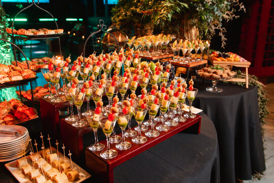 Catering setup featuring an elegant table with hors d'oeuvres and glasses for a social event.