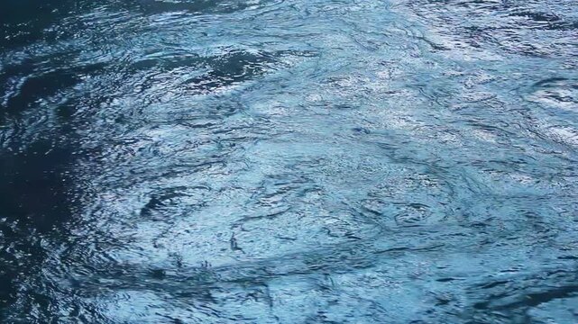 Icy river water surface drifting slush ice. Closeup cold winter texture.