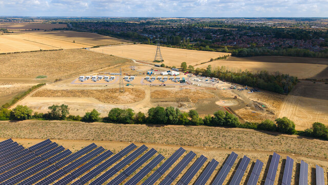 Aerial view of Eaton Socon Substation, solar farm, and battery energy storage systems surrounded by agricultural fields and rural landscape in St. Neots, England, United Kingdom.