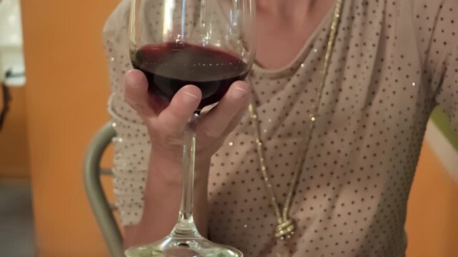 blonde woman sipping red wine at an elegant restaurant dinner, enjoying a romantic, celebratory evening of fine dining, luxury and relaxed conviviality