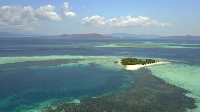 aerial footage of tourists visiting tiny sandbar Taka Makassar in tropical sea