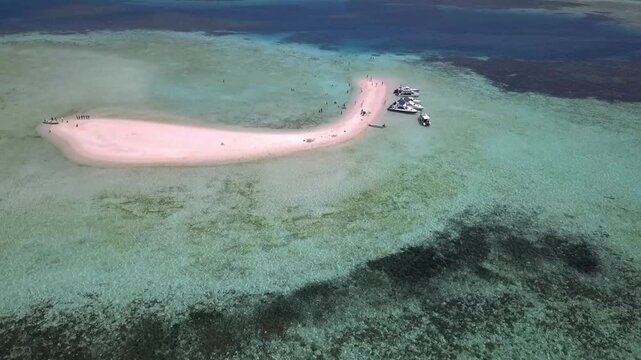 Drone orbit shot around small white sandbank Taka Makassar in East Nusa Tenggara