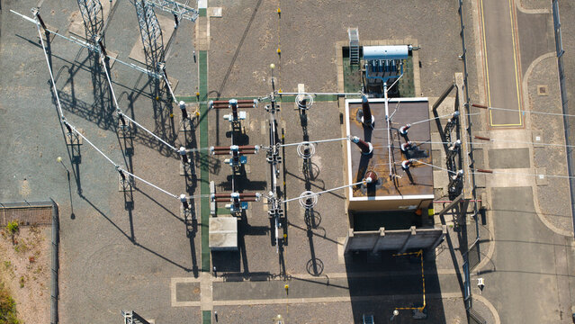 Aerial view of Eaton Socon Substation featuring electrical transformers, high-voltage equipment, and power lines in St. Neots, England, United Kingdom.
