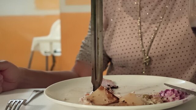 Server carving slices of roasted ham from a large metal skewer directly onto a plate at a Brazilian churrascaria, offering a traditional dining experience with grilled meat