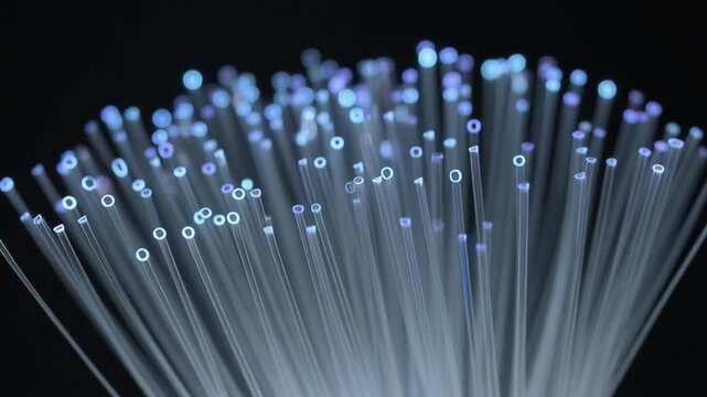 Illuminated optical fibers form a glowing, intricate network, showcasing the vibrant flow of information and the powerful essence of advanced telecommunication technology reaching out
