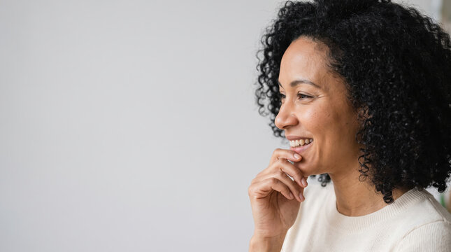 Smiling woman feeling happy and confident, enjoying a humorous moment while thinking or reflecting, expressing joy and optimism with copy space