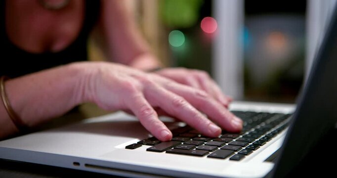 Woman Typing on Laptop: Close-up of a woman's hands actively typing on a laptop keyboard, highlighting the act of digital communication and work.