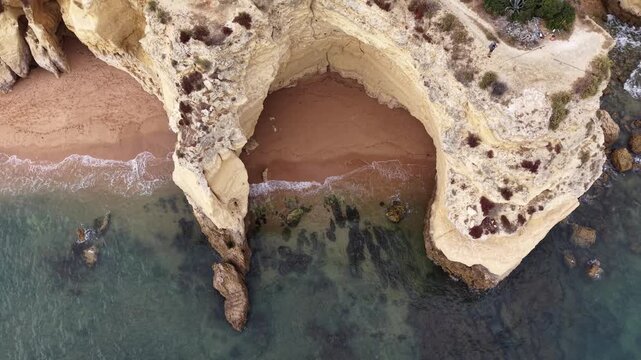 Aerial view of a natural arch on a secluded beach in portugal