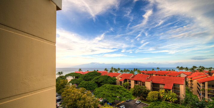 cinderblock wall with a view over clay tile roofs in front of the Pacific Ocean, Maui, Hawaii