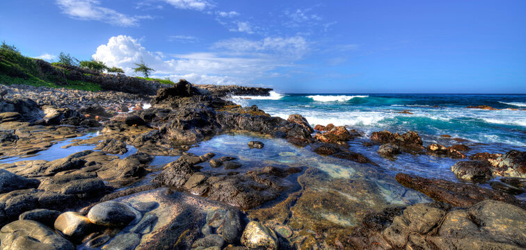 rock tidal pools lining the edge of DT Fleming beach big waves, Maui, Hawaii