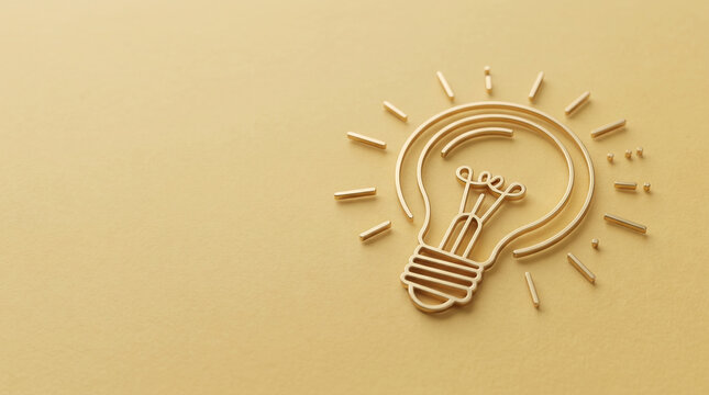 Golden light bulb emblem with radiating lines on yellow background