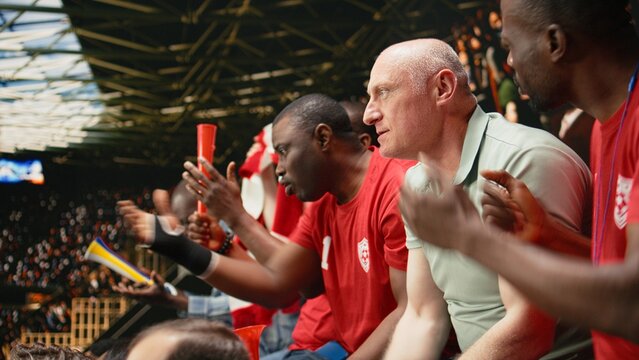 Passionate woman football supporter cheers with a red team crowd during an intense live soccer match highlighting fan chants sports inclusion and equality.