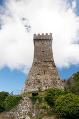 Obraz premium Tower of the medieval fortress of Radicofani, an imposing historic landmark overlooking the Val d’Orcia landscape in southern Tuscany, Italy.