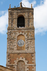 Obraz premium Bell tower of the Collegiate Church of Saints Leonard and Cassian in San Casciano dei Bagni, a historic Tuscan village in the province of Siena, Italy.