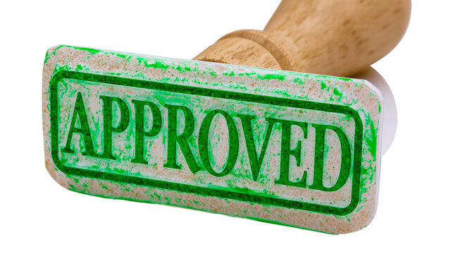 Isolated rubber stamp with green 'APPROVED' text, hand holding stamp, indicating acceptance