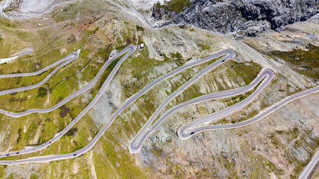 Aerial view of the famous Stelvio Pass Serpentines featuring dramatic hairpin turns winding through the rugged alpine landscape of Stilfs, Trentino-Alto Adige, Italy.